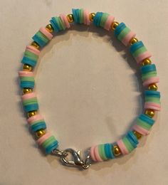 a bracelet with multicolored beads and a metal clasp on it's end