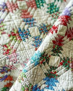 closeup of an old quilt with colorful designs