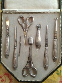 an assortment of antique silverware in a box