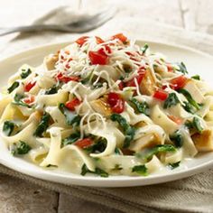 Creamy Chicken Pasta Florentine with Knorr® Pasta Sides™ - Butter & Herb, Cream Cheese, Soften, Spinach Leaves, Cut Up Cooked Chicken, Shredded Mozzarella Cheese, Tomatoes.