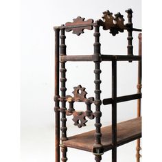 an old wooden shelf with ornate carvings on the top and bottom, against a white background