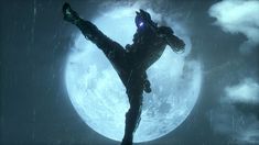 a man standing in front of a full moon with his arms out to the side