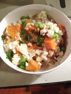 a white bowl filled with rice and vegetables