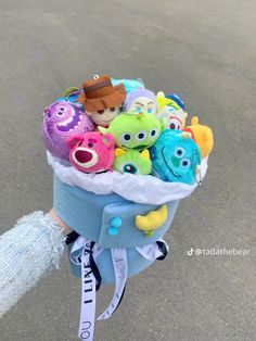 a person holding a bunch of stuffed animals in their hand with the caption's name on it