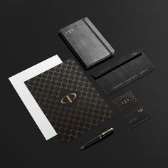 black and gold stationery with monogrammed business cards, envelopes and pen