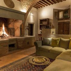 a living room filled with furniture and a fire place next to a wall mounted fireplace