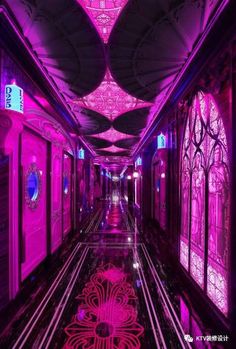 the hallway is lit up with pink lights and intricate designs on the ceiling, along with decorative glass windows