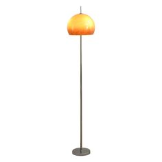 a floor lamp with an orange shade on the top and one light on the bottom