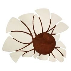 a brown and white flower shaped object on a white background, with the petals arranged around it's center