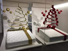 there are two beds that have been decorated with gold and red ribbons on the bed