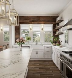 a large kitchen with white cabinets and marble counter tops, along with an island in the middle