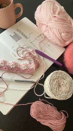 yarn and crochet supplies laid out on a table next to a coffee cup