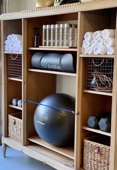 an exercise ball sits on top of a wooden shelf