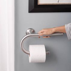 a person holding a roll of toilet paper in their hand