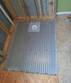 a bathroom floor that is being remodeled with wood and metal grates on the floor