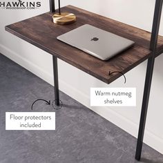 a wooden desk with metal legs and a laptop on it, labeled in the following words