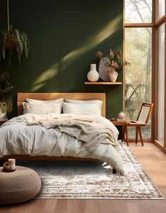 a bedroom with green walls and white bedding in the corner, along with potted plants