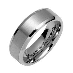 a white gold wedding ring with an inscription on it