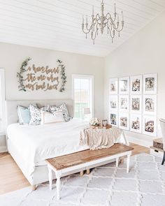 a bedroom with white furniture and chandelier above the bed is featured on instagram