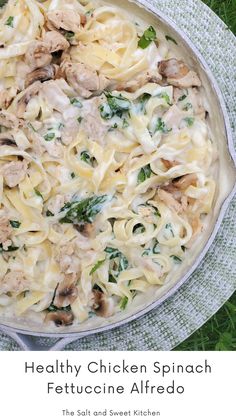 chicken spinach fettuccine alfredo in a skillet with the title above it