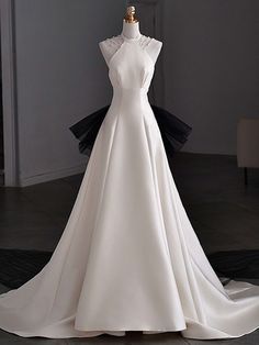 a white wedding dress on display in a room