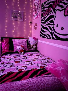 a bedroom decorated in pink and black with hello kitty bedding, wall decor and lights