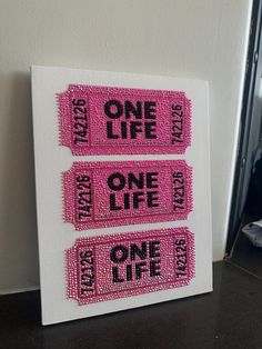 two pink tickets with one life on them