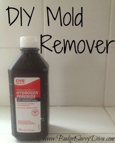 a bottle of diy mold remover sitting next to a white tile wall with the words diy mold remover on it