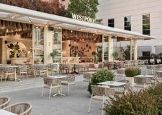 an outdoor dining area with tables and chairs