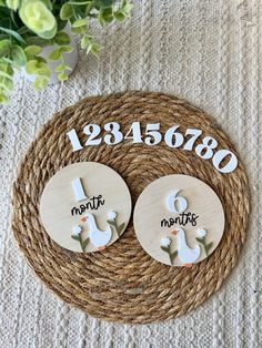 two wooden buttons with numbers and flowers on them