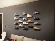 a living room filled with lots of shoes on the wall