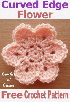 the crochet flower is shown in pink