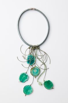 Mixed-Media Necklace - Cool, classy green. Green agate slices mingle with natural green fluorite, crystal, glass and hand-knotted leather on this unique fringe necklace. The substantial leather cord is finished with a magnetic clasp. 19 inches with a ten inch drop. Artistic Green Handmade Necklace, Unique Green Necklace With Large Beads, Unique Green Glass Necklaces, Unique Turquoise Glass Necklaces, Nature-inspired Freeform Natural Stone Necklace, Leather Statement Necklace, Agate Necklaces, Mixed Media Necklace, Agate Slices