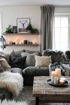 a living room filled with lots of furniture and candles on top of it's coffee table