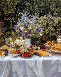 a table topped with lots of different types of foods and desserts on top of it