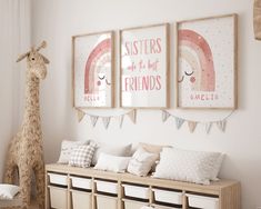 a child's room decorated in pink, white and grey with pictures on the wall