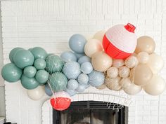 a fireplace decorated with balloons and streamers