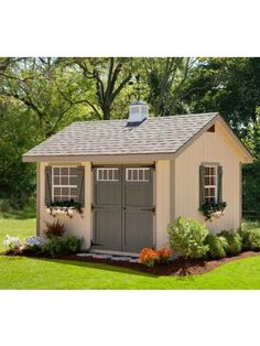 a small shed with windows and shutters on the roof is shown in front of some trees