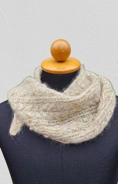 a mannequin wearing a white knitted cowl