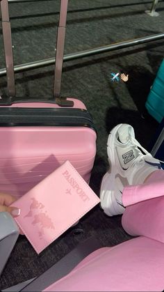 a person sitting on the ground with their feet up next to luggage and a passport