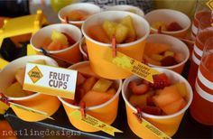 cups filled with fruit are sitting on a table