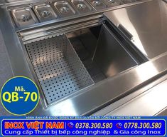 a stainless steel stove top with an open vent on the front and bottom shelf for cooking utensils