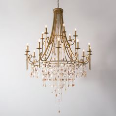 a chandelier hanging from the ceiling in a room with white walls and flooring