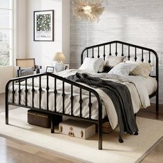 a black metal bed frame in a bedroom