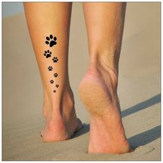 a woman's foot with paw prints on it and the bottom of her leg