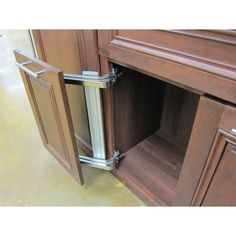 an open cabinet door in a kitchen with stainless steel handles and pulls on the doors