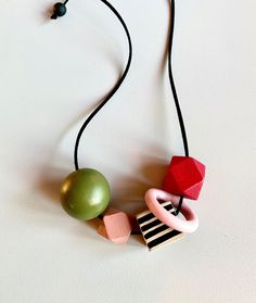 Each wooden bead is hand painted by me and each of them is unique.   They are super easy to combine with your outfit and will make you smile :)   All my products are comfortable and lightweight they are attached with soft cordon.   Each necklace can be personalized please feel free to contact me for your special orders.   I use acrylic paint and combine with soft Vegan cord.   They are all carefully Varnished that they are resistible to products like perfume etc.   They are water resistant but n Playful Red Adjustable Necklace, Weird Jewelry, Chunky Bead Necklaces, Wooden Bead Necklaces, Large Necklace, Designer Necklace, Wooden Necklace, Spring Jewelry, Necklace Red