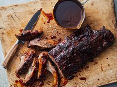 bbq ribs and barbecue sauce on a cutting board