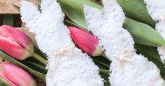 pink and white tulips are sitting on the table