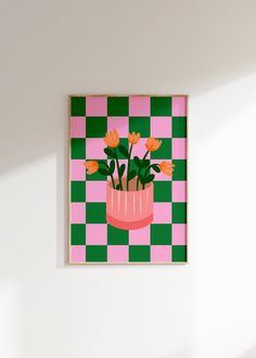 a pink vase with orange flowers on a green and white checkerboard pattern wall